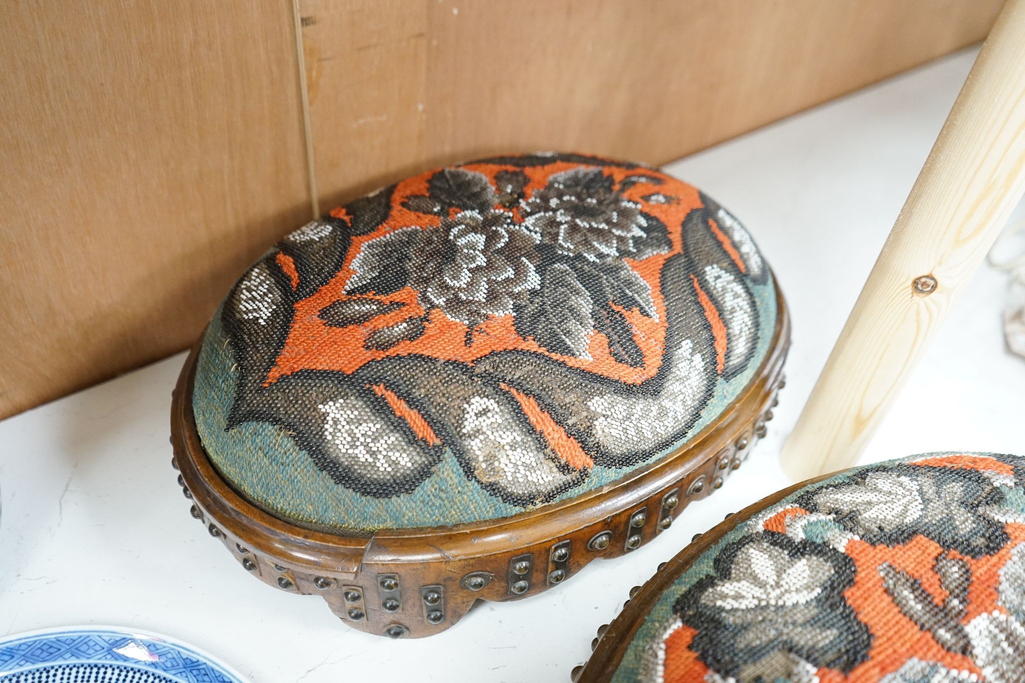 A pair of Berlin beadwork footstools, 38cm